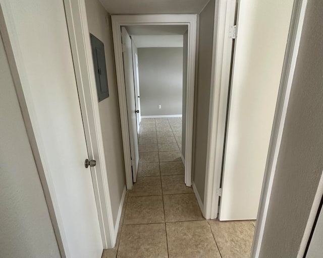 corridor with electric panel and light tile patterned floors