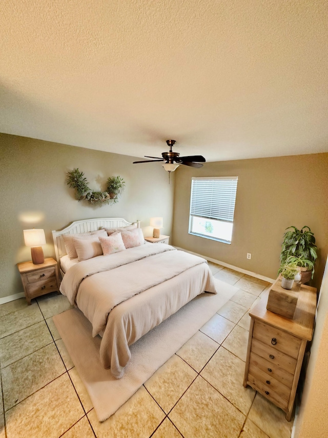 tiled bedroom with a textured ceiling and ceiling fan