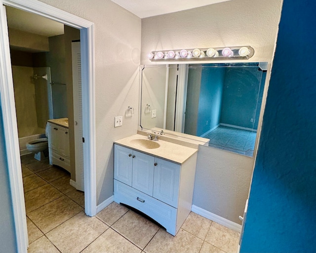 bathroom with vanity, toilet, and tile patterned floors