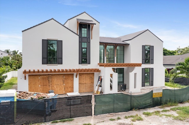 back of property with a garage and central AC unit