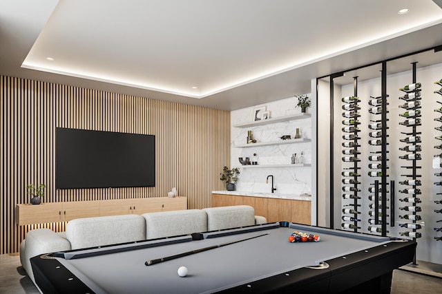 rec room with bar, a tray ceiling, and billiards