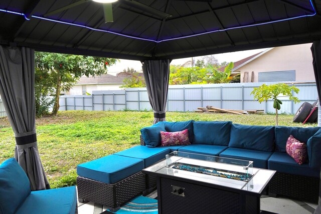 view of patio with a gazebo and an outdoor living space with a fire pit