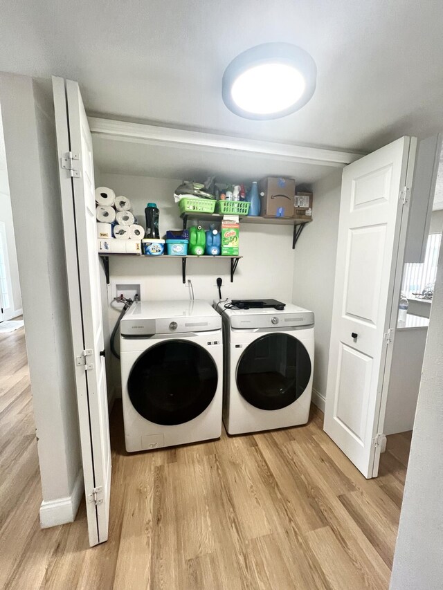 laundry area featuring washer and dryer and light wood-type flooring