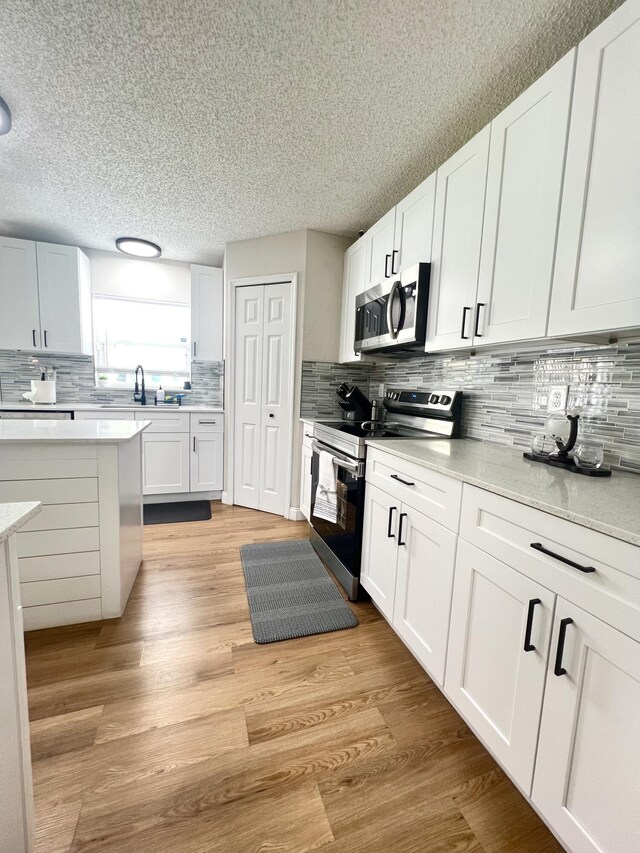 kitchen with stainless steel appliances and white cabinetry