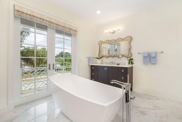 bathroom with vanity, a bath, plenty of natural light, and french doors