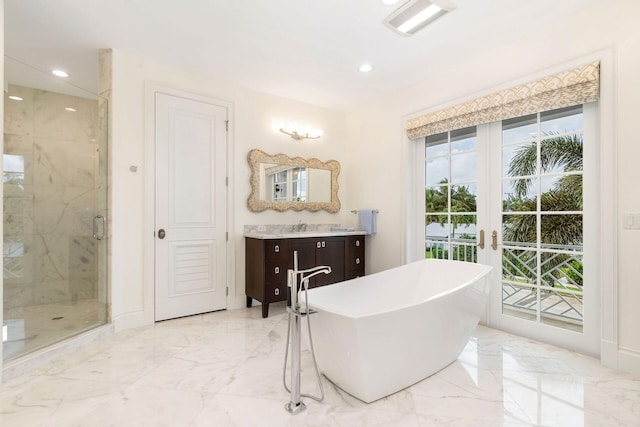 bathroom featuring vanity and separate shower and tub