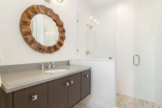 bathroom featuring tile patterned flooring, walk in shower, and vanity