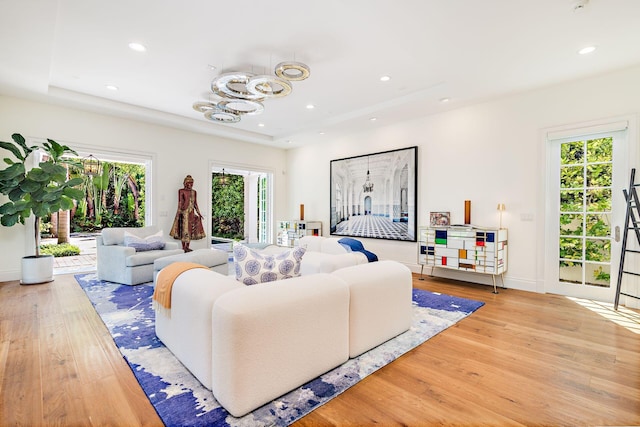 living room featuring hardwood / wood-style flooring and a chandelier