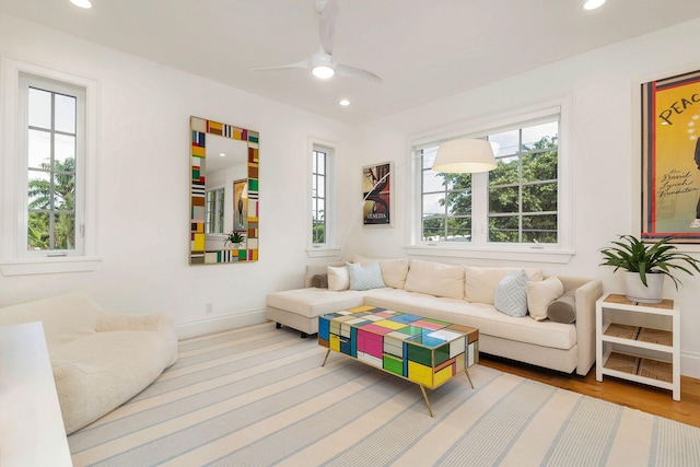 living room featuring hardwood / wood-style flooring and ceiling fan