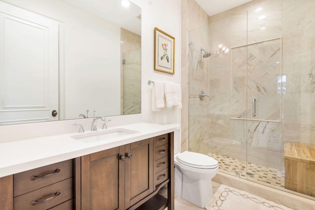 bathroom with vanity, toilet, a shower with shower door, and tile patterned flooring