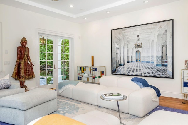 living room with light hardwood / wood-style flooring and an inviting chandelier