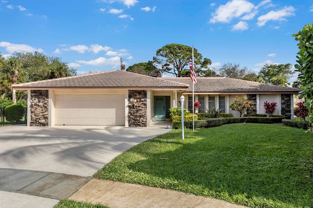 ranch-style house featuring a front yard and a garage