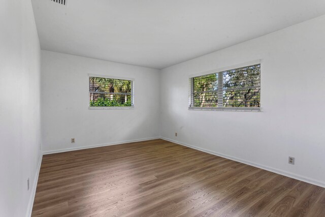 spare room featuring wood-type flooring