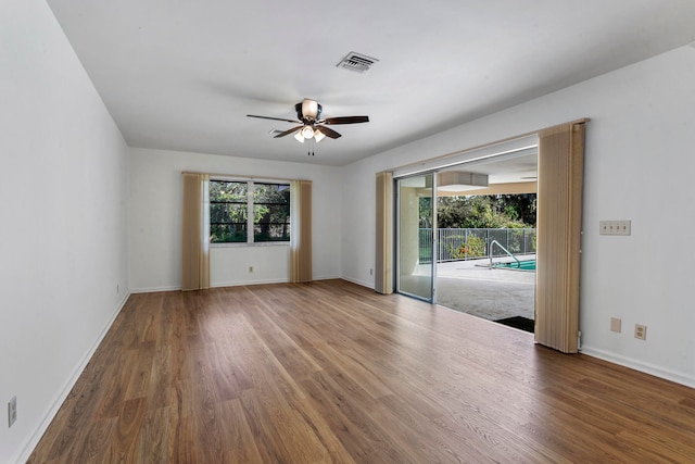 spare room featuring ceiling fan and dark hardwood / wood-style flooring