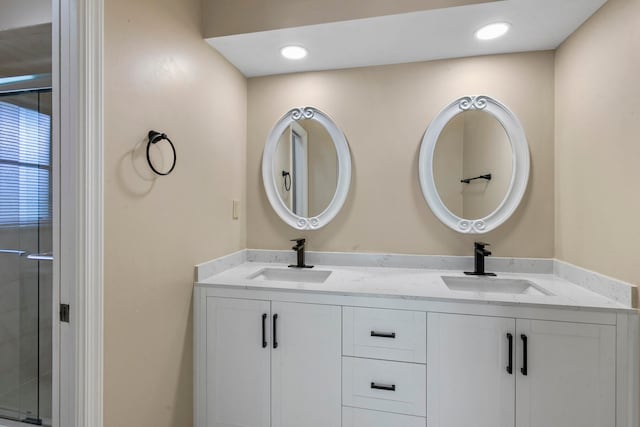 bathroom featuring walk in shower and vanity