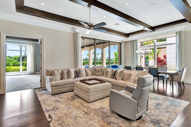 living room featuring ceiling fan with notable chandelier, dark wood-type flooring, ornamental molding, and a wealth of natural light