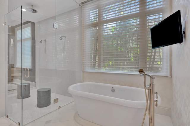 bathroom featuring plus walk in shower, tile patterned flooring, and plenty of natural light