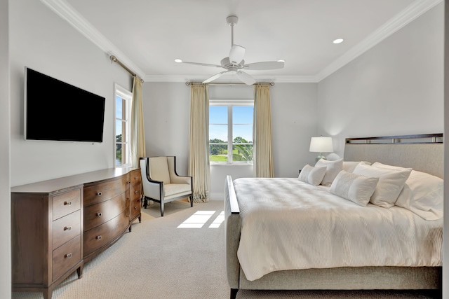 carpeted bedroom with ceiling fan and ornamental molding