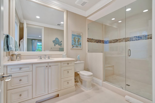 bathroom with crown molding, vanity, toilet, and walk in shower