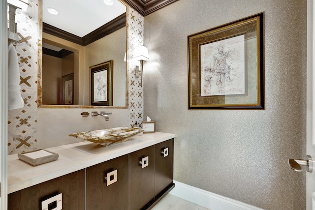 bathroom featuring crown molding and vanity