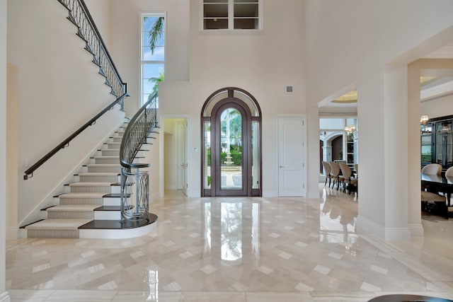 entryway with a high ceiling and an inviting chandelier