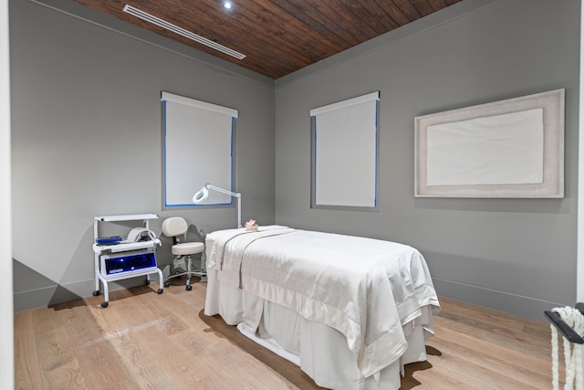 bedroom featuring ornamental molding, wooden ceiling, and light hardwood / wood-style floors