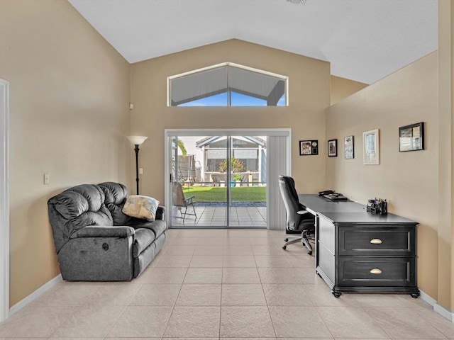 tiled office space featuring vaulted ceiling