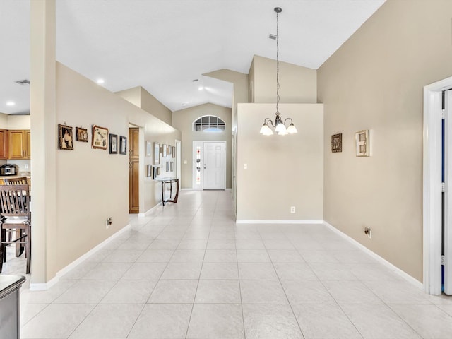 interior space featuring lofted ceiling and a chandelier