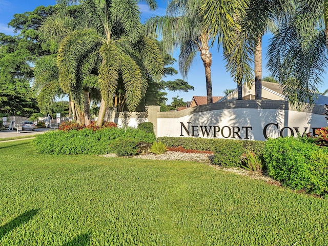 community sign featuring a lawn