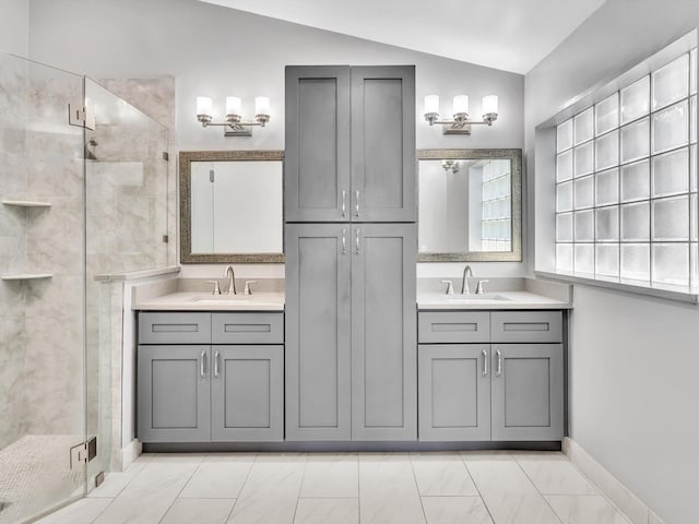 bathroom with vanity, vaulted ceiling, and an enclosed shower