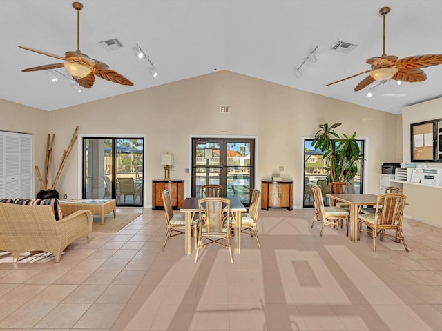 interior space featuring rail lighting, ceiling fan, and a wealth of natural light