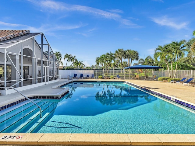 view of pool with a lanai and a patio