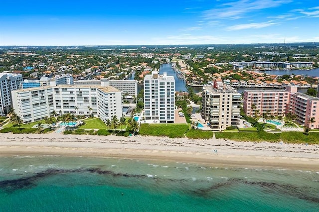 birds eye view of property with a view of the beach and a water view