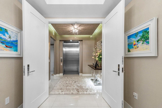 corridor with light tile patterned floors and elevator