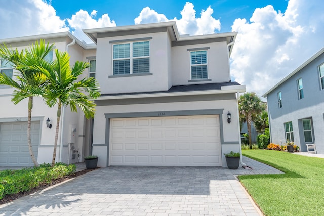 view of front of property with a garage and a front yard