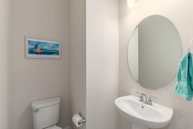 bathroom featuring toilet and sink