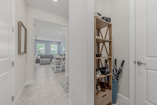 corridor featuring light tile patterned floors