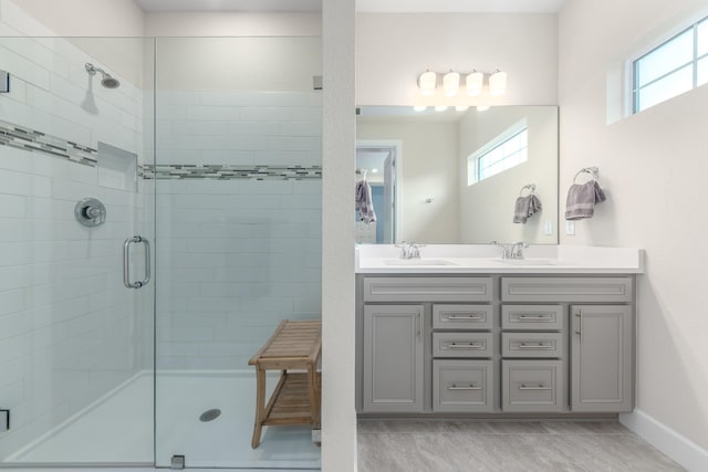 bathroom featuring vanity and a shower with shower door