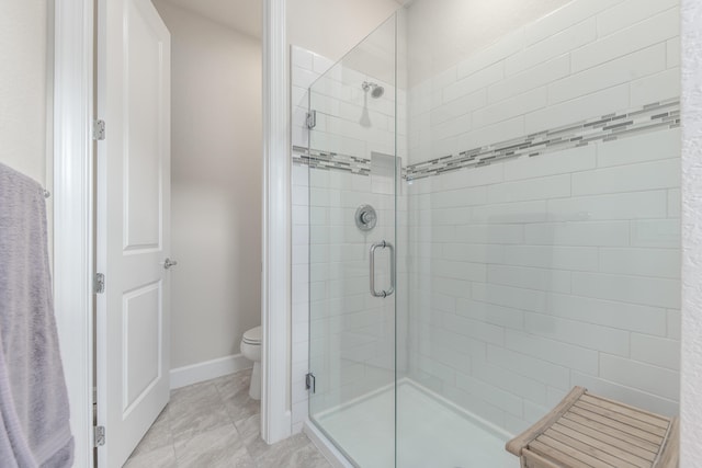 bathroom featuring walk in shower and toilet