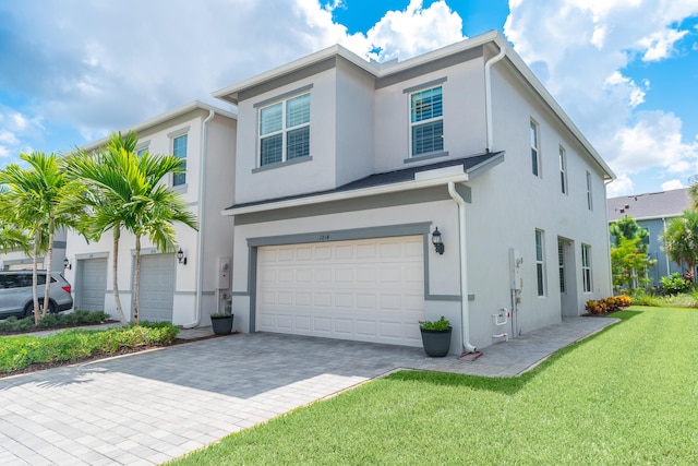 view of front facade with a front yard and a garage