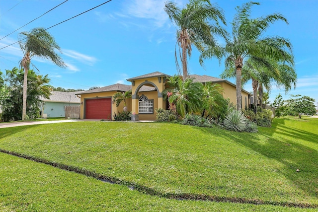 mediterranean / spanish home with a garage and a front yard