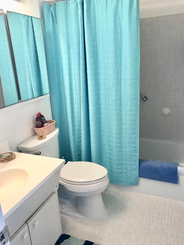 full bathroom featuring toilet, tile patterned floors, vanity, and shower / bathtub combination with curtain