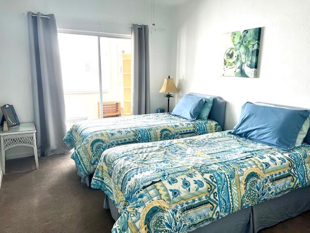 bedroom with dark colored carpet