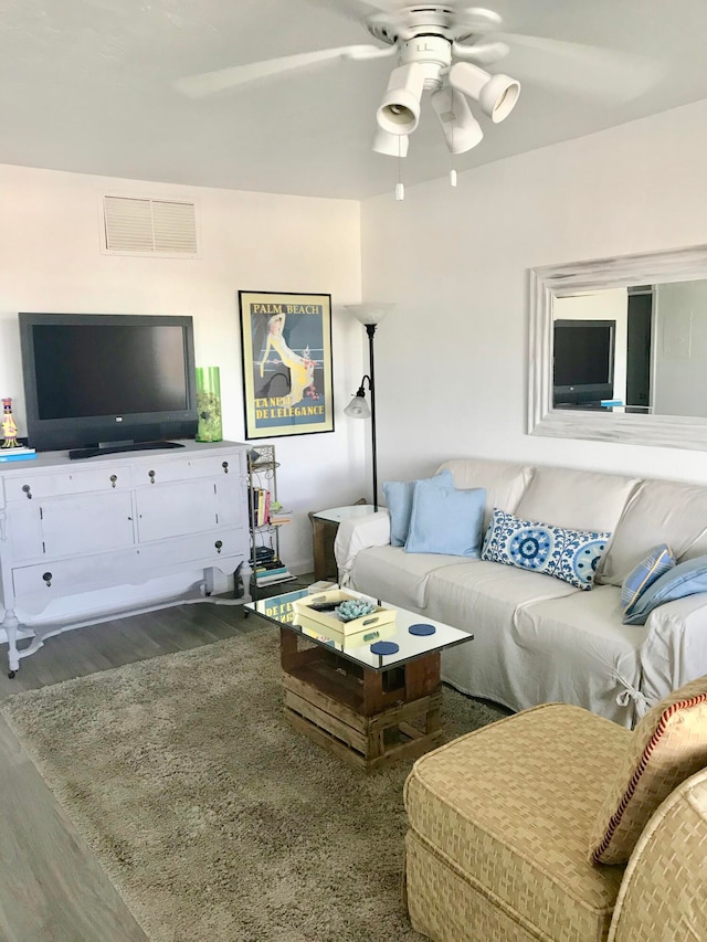 living room featuring ceiling fan and hardwood / wood-style flooring