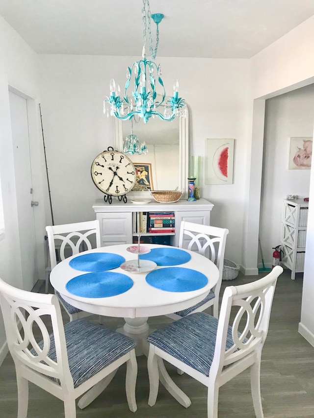 dining space with a notable chandelier and hardwood / wood-style floors