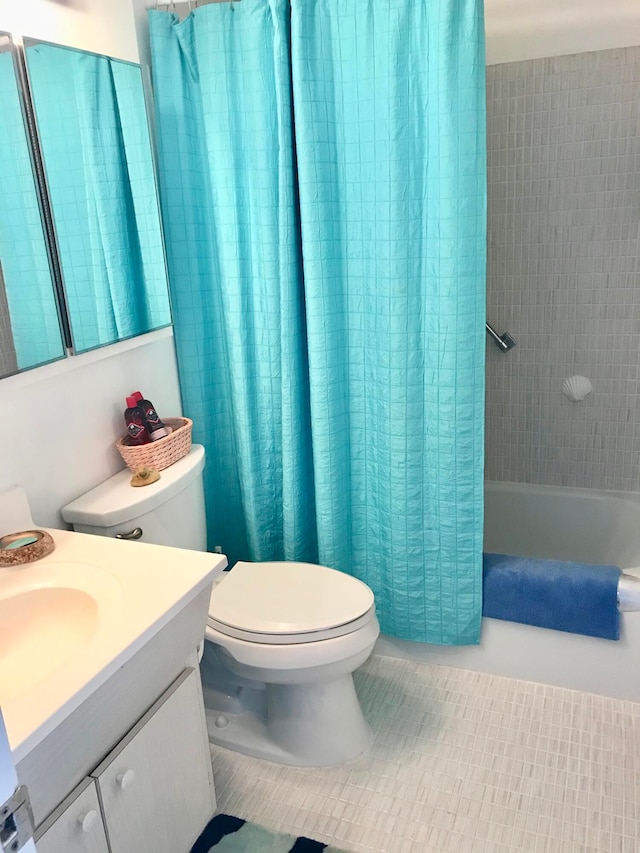 full bathroom with shower / tub combo with curtain, vanity, toilet, and tile patterned floors