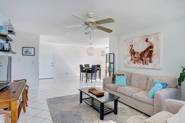 living room with ceiling fan with notable chandelier and light tile patterned flooring