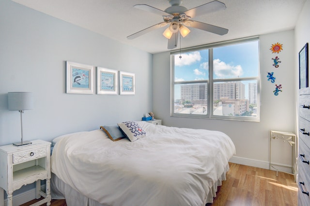 bedroom featuring ceiling fan and light hardwood / wood-style flooring