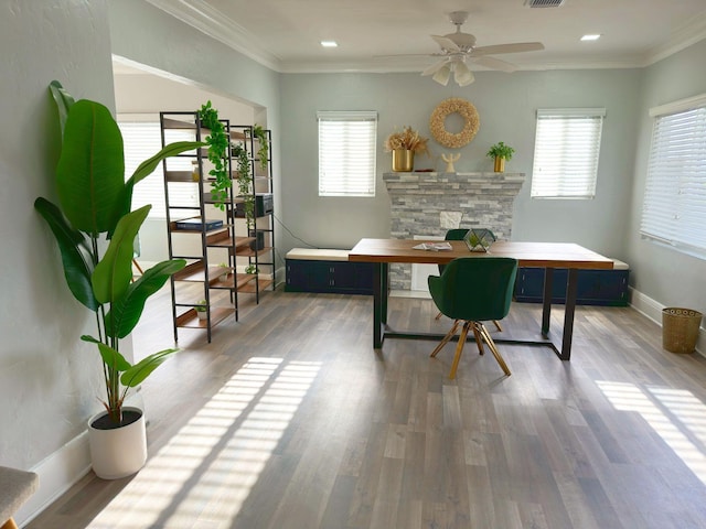 office with baseboards, wood finished floors, visible vents, and ornamental molding