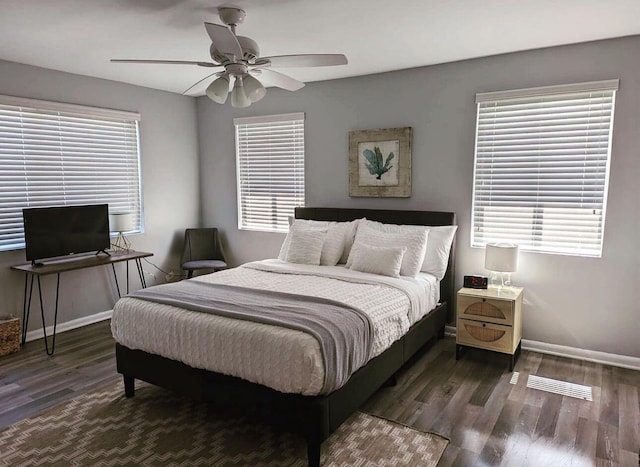 bedroom featuring a ceiling fan, wood finished floors, and baseboards